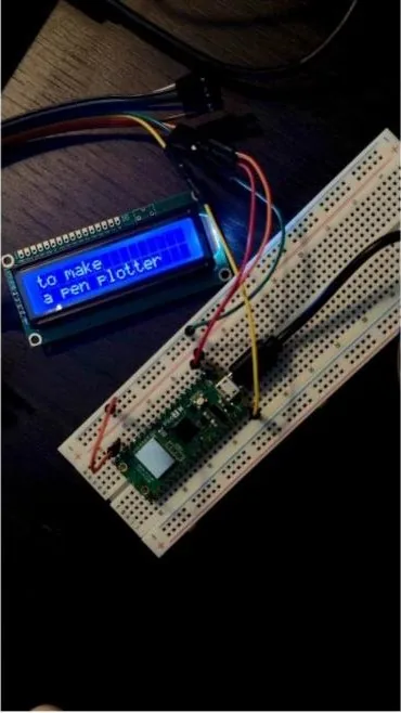 A Raspberry Pi Pico on a breadboard wired to an LCD reading to make a Pen Plotter
